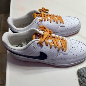 Nike White Low-Top Sneakers with Navy Swoosh and Yellow